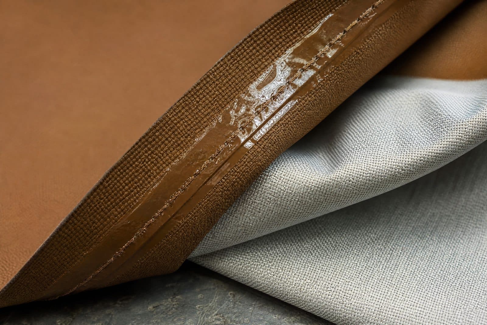 A seam sealed on the underside with a continuous strip of heat-applied tape running over the stitch line.